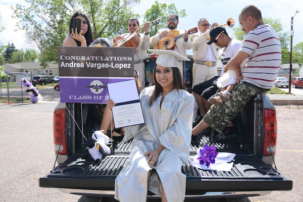 Student posing on a truck for graduation