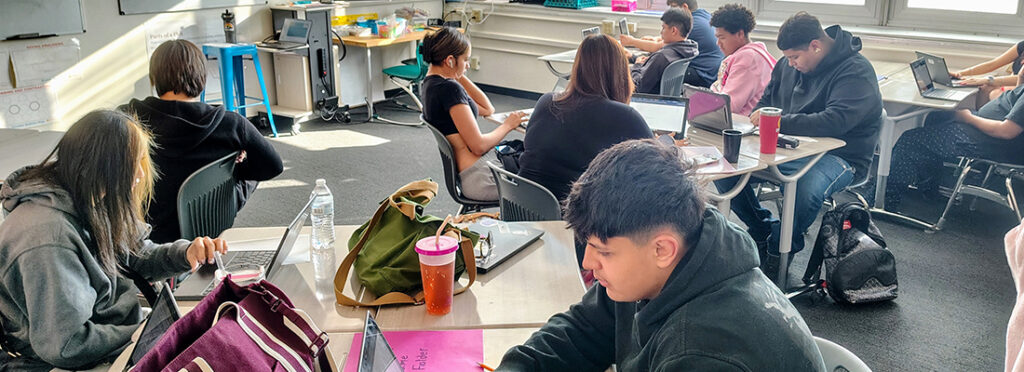 Students doing work on their computer in class.
